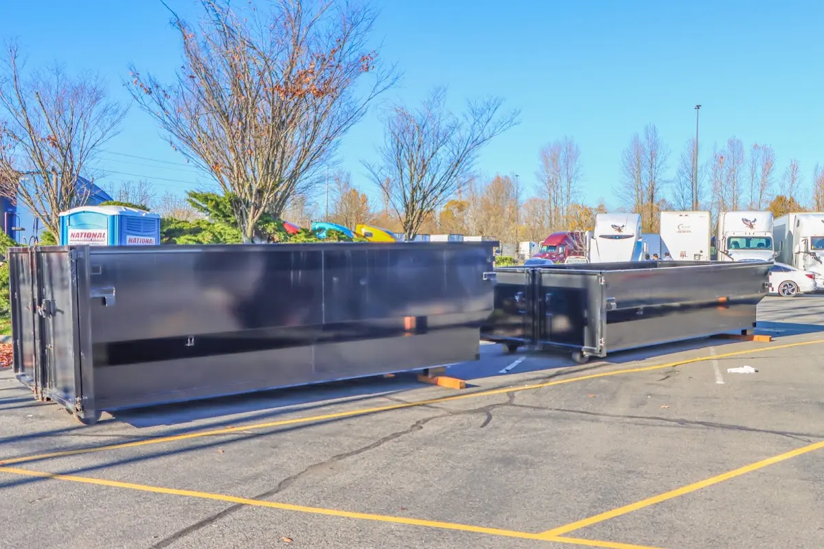 Professional dumpster rental service with roll-off container on residential driveway in Texas